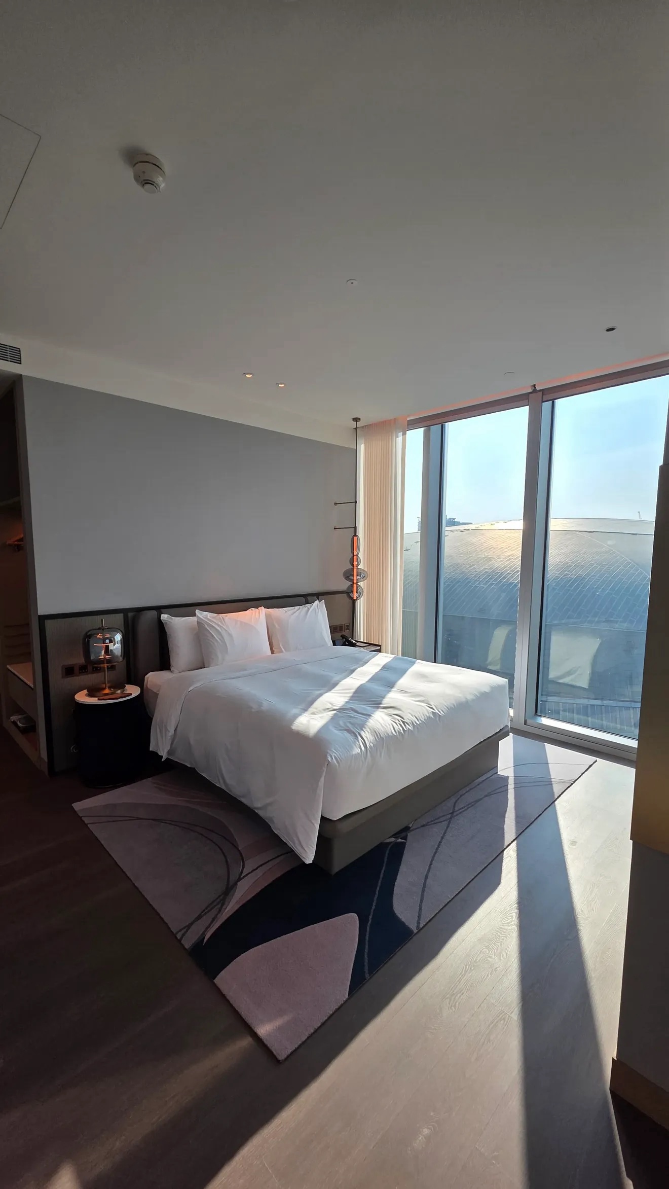 Bedroom with king bed and floor-to-ceiling windows