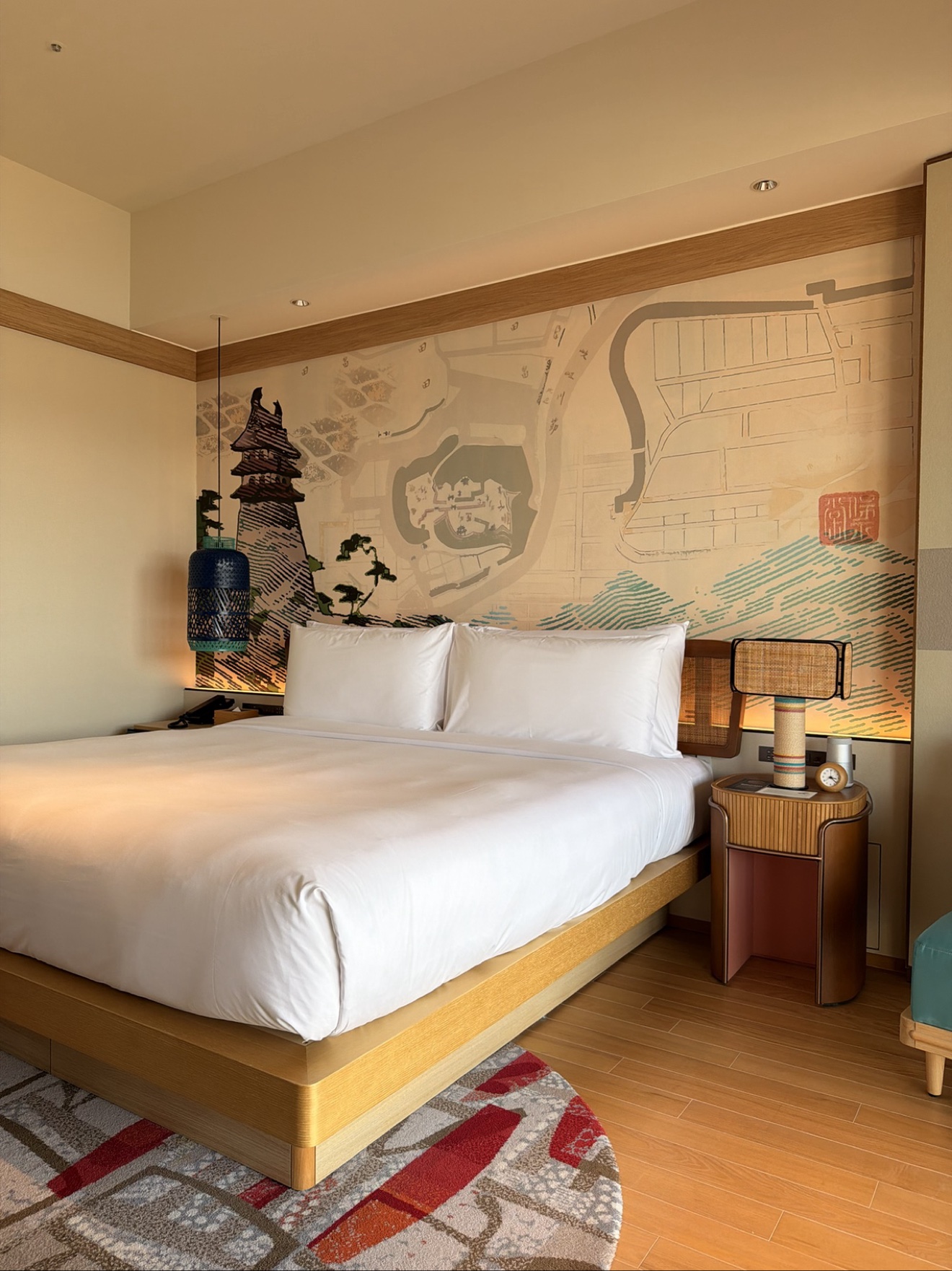 Bed and antique map mural close-up