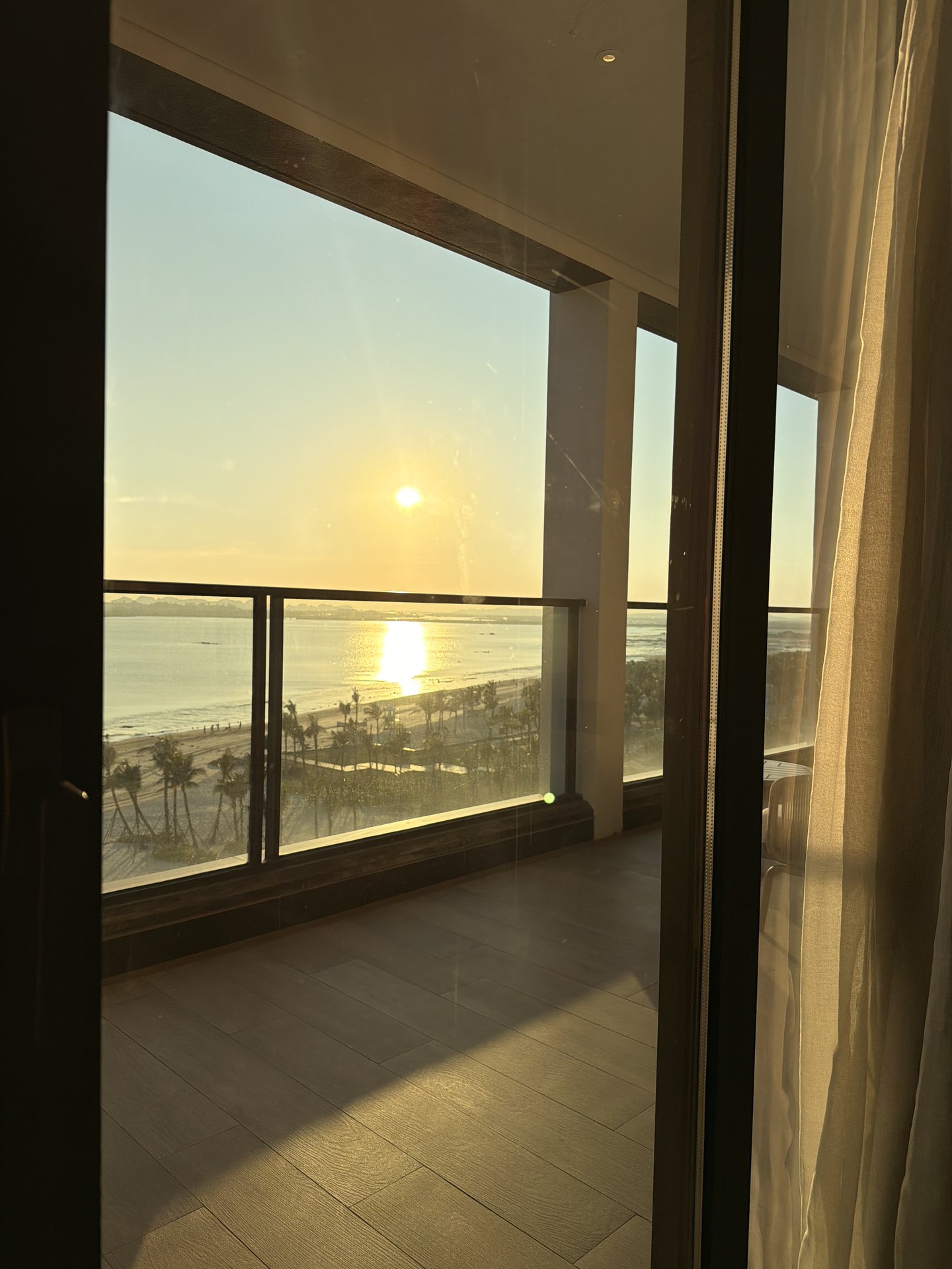 バルコニーからの夕日。金色に染まる海面。