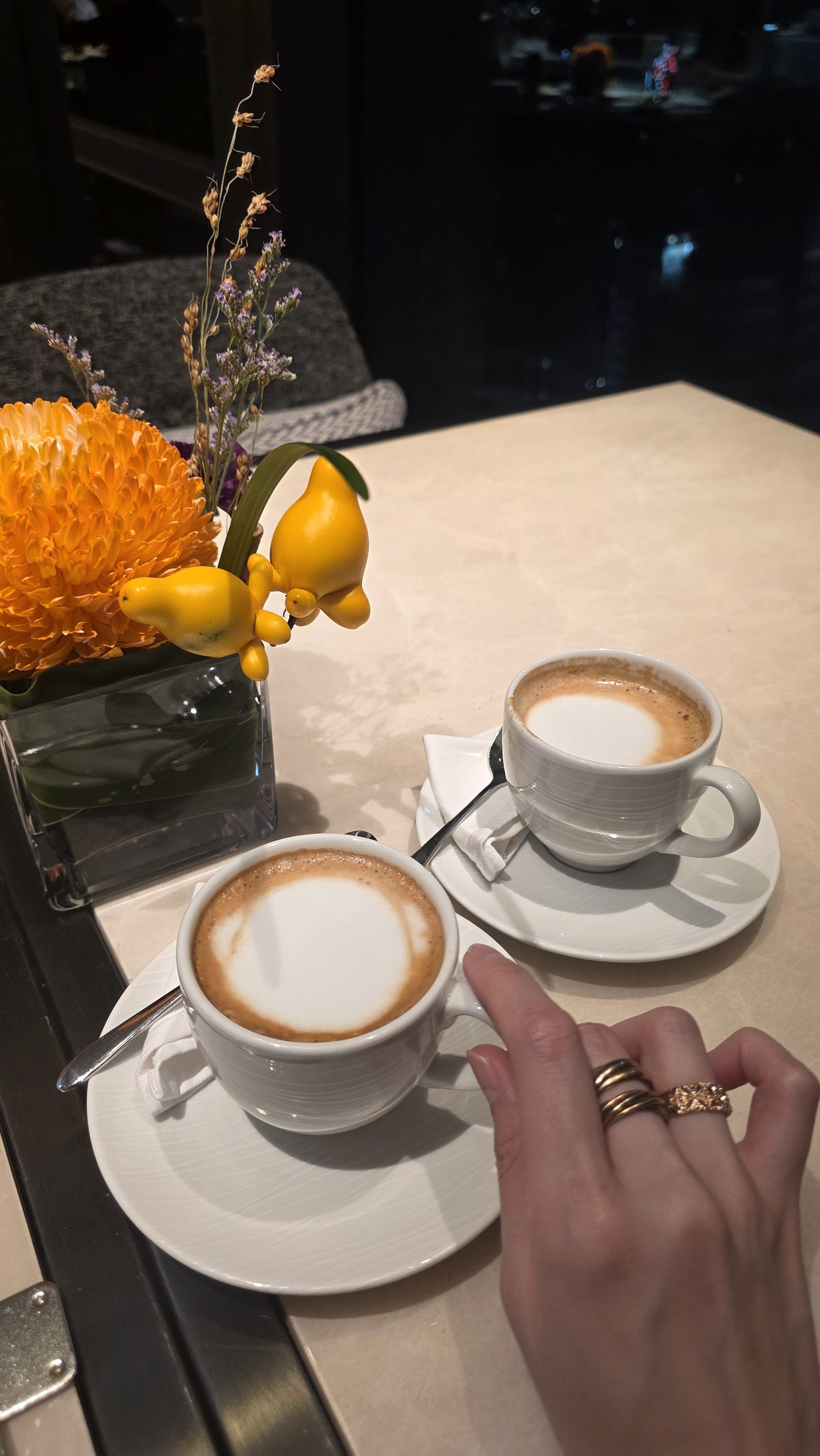 Closing the evening: two hot lattes and the flowers on the table
