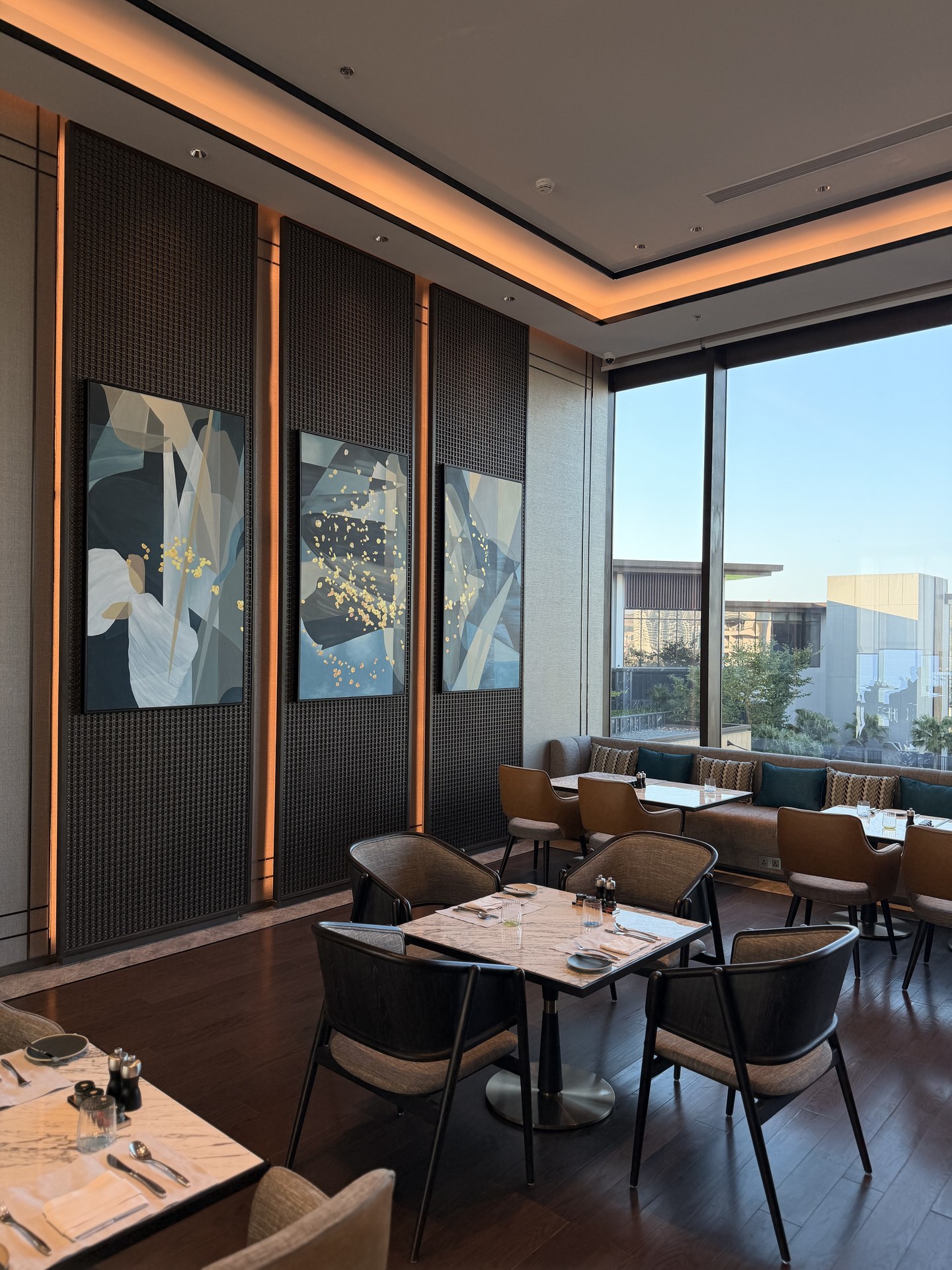 Window-side dining tables and wall art.