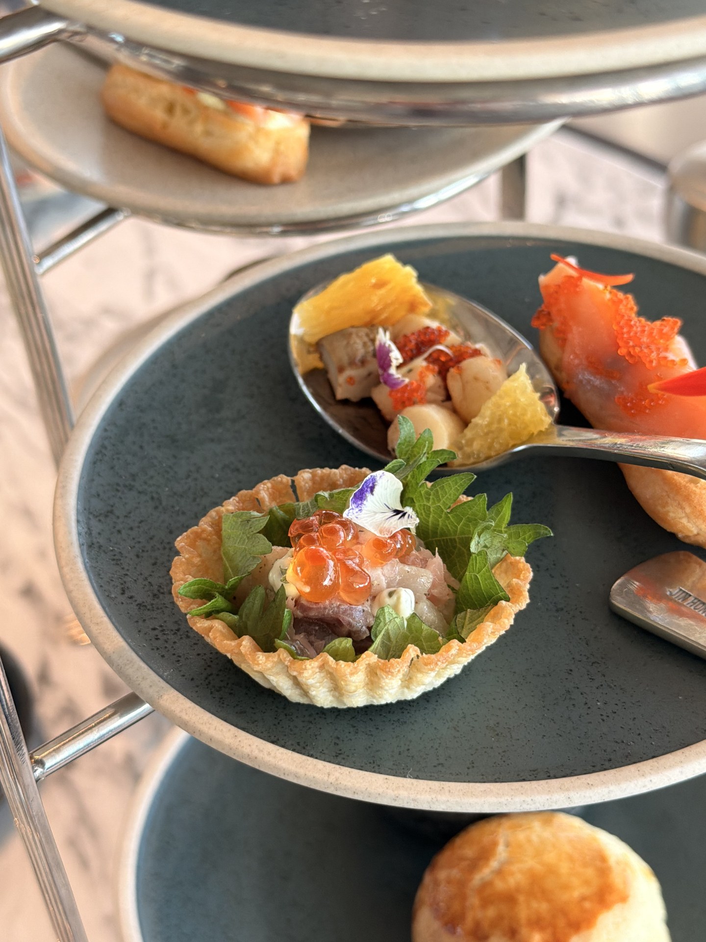 A salmon tartlet and spoon canapés.