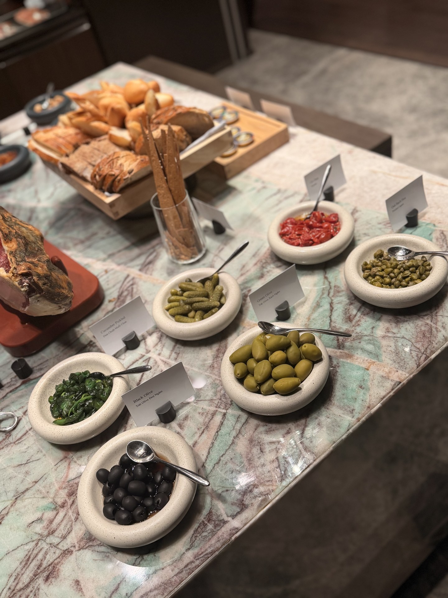 Olives and small condiments, bowl by bowl.